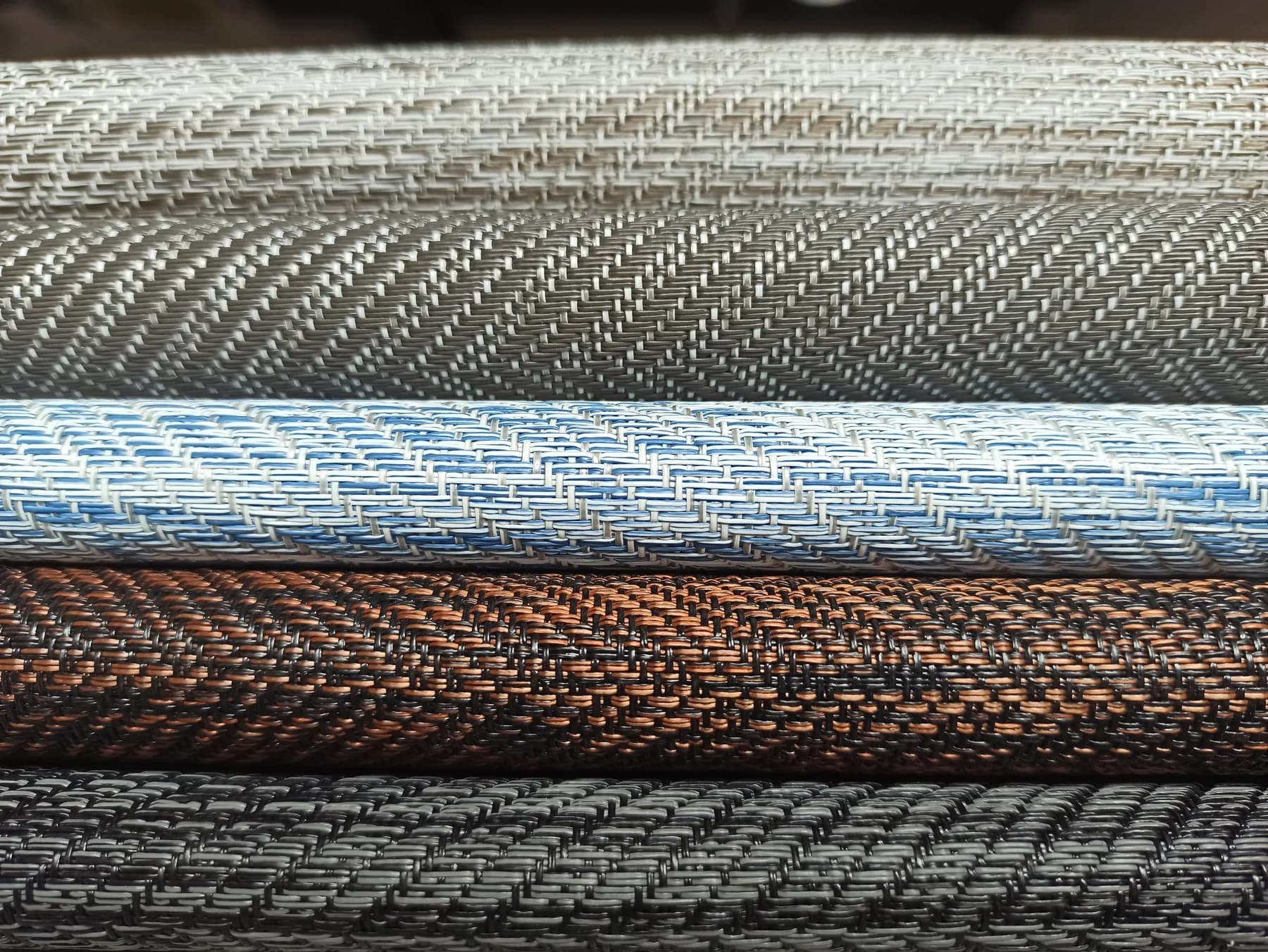 Rolls of ZAN woven vinyl in a range of weaves and colourways